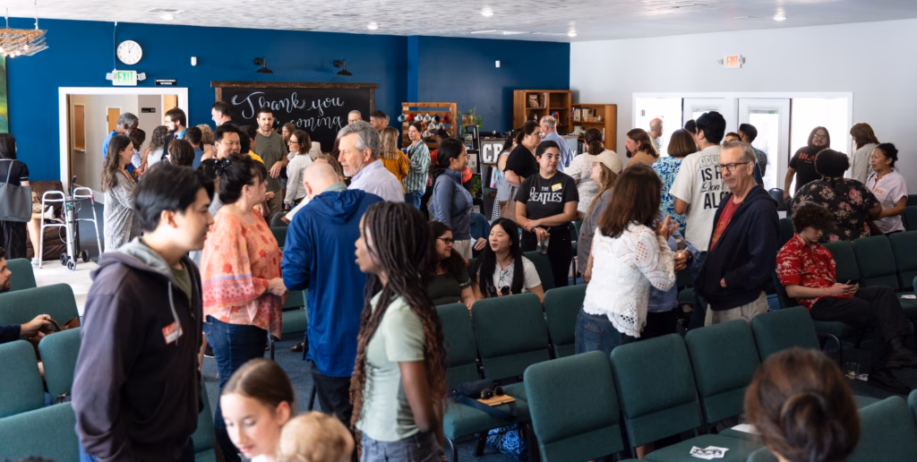 A congregation greets each other.